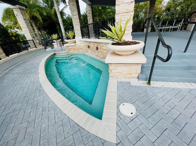 view of swimming pool with a patio