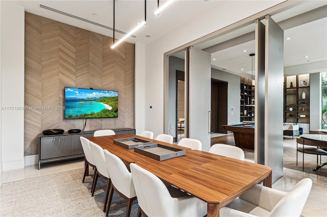 dining space with light tile patterned floors and billiards