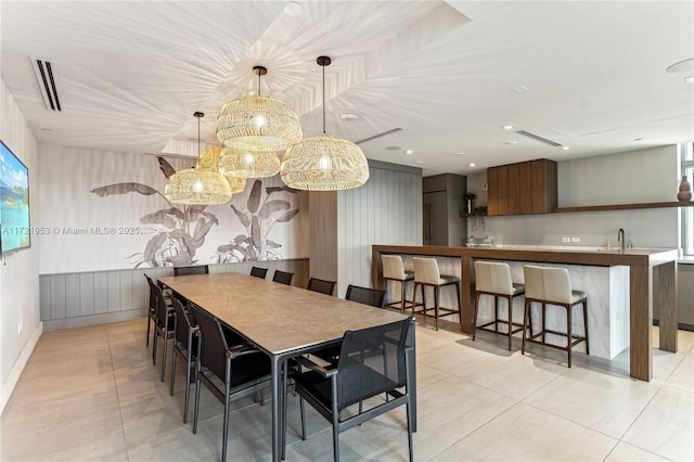 tiled dining room featuring sink