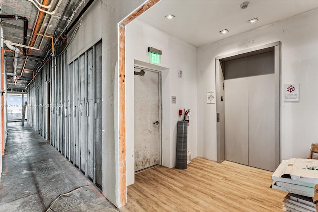 hall featuring wood-type flooring and elevator