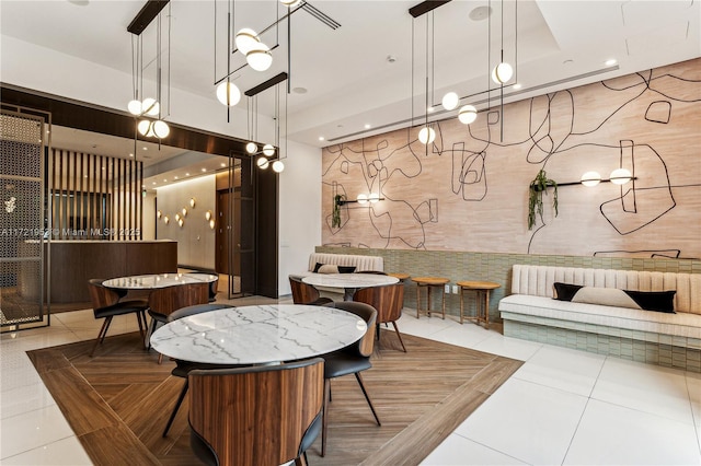 dining space with light tile patterned floors and radiator