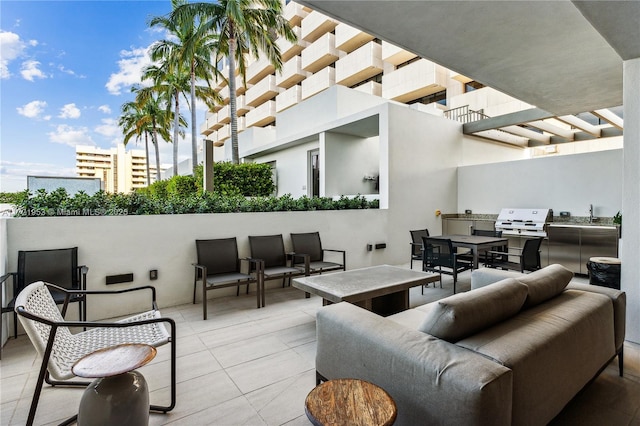 view of patio featuring outdoor lounge area, an outdoor kitchen, and a grill