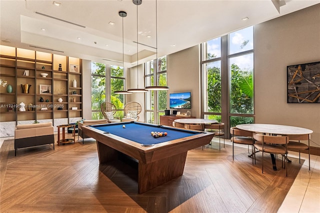 recreation room with floor to ceiling windows, plenty of natural light, parquet floors, and billiards