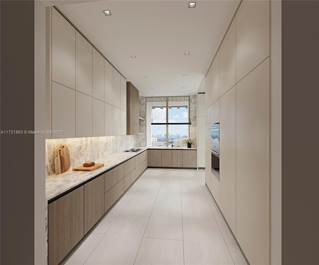 kitchen featuring light stone countertops, sink, backsplash, black stovetop, and tile walls