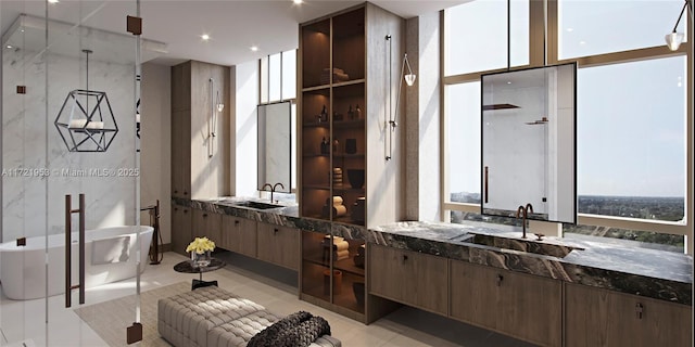 bathroom with tile patterned flooring, vanity, a bathtub, and a wall of windows