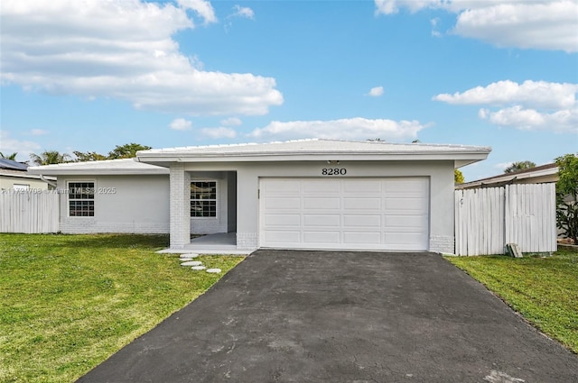 view of front of home featuring a garage and a front yard