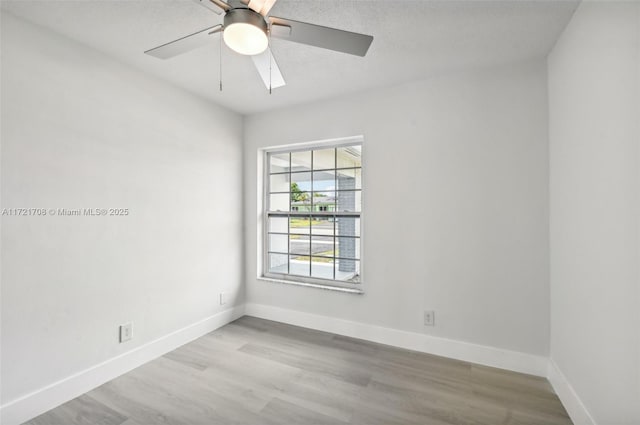 spare room featuring light hardwood / wood-style flooring and ceiling fan