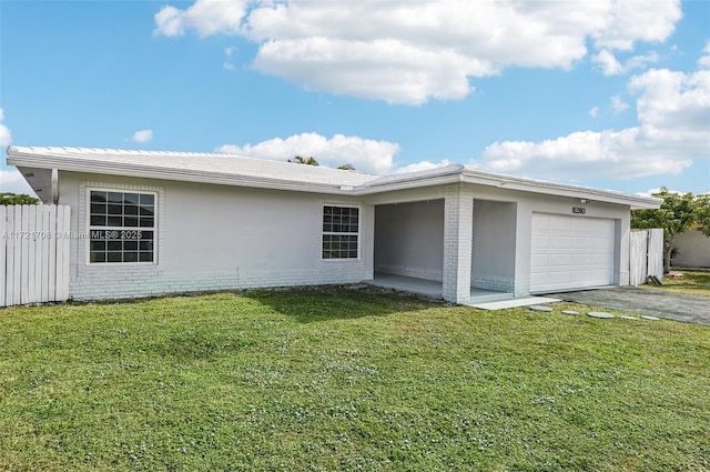 view of front of house featuring a front yard and a garage