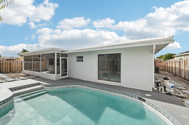 view of pool featuring a sunroom and central AC unit