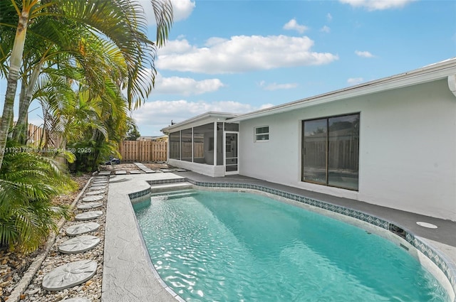 view of swimming pool with a sunroom