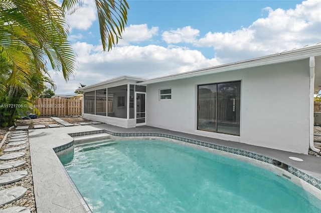 view of pool featuring a patio area and a sunroom