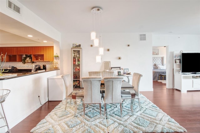 dining room with dark hardwood / wood-style flooring