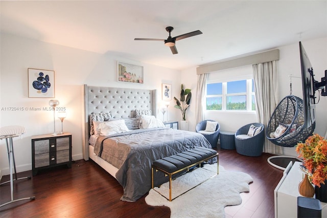 bedroom with ceiling fan and dark wood-type flooring