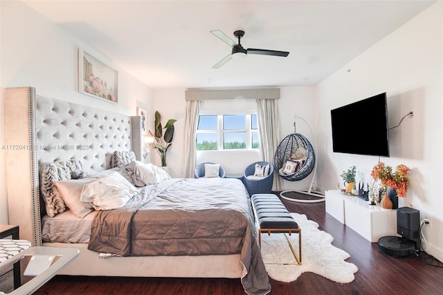 bedroom with dark hardwood / wood-style floors and ceiling fan