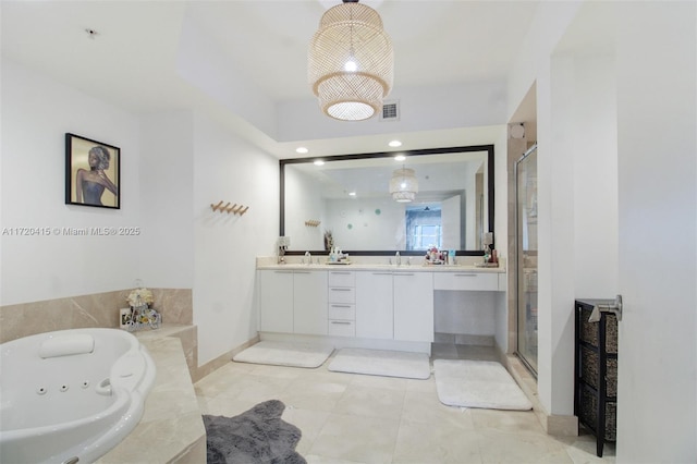 bathroom with tile patterned flooring, vanity, and independent shower and bath