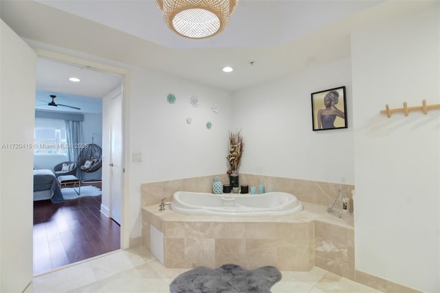 bathroom featuring tile patterned floors, tiled tub, and ceiling fan