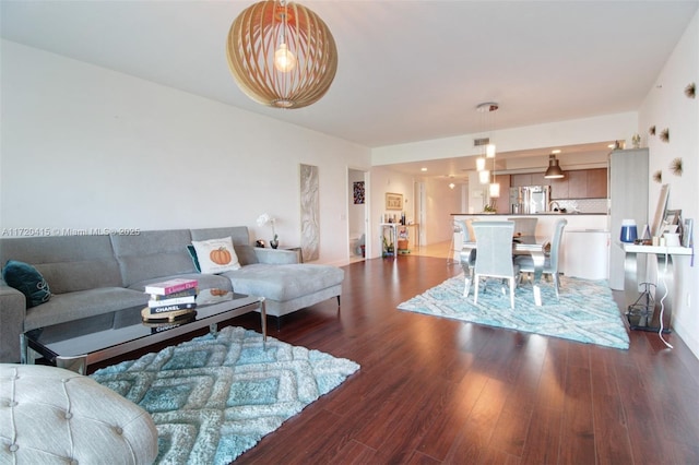 living room with dark hardwood / wood-style flooring