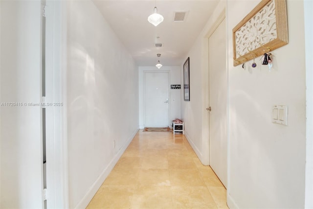 corridor featuring light tile patterned flooring