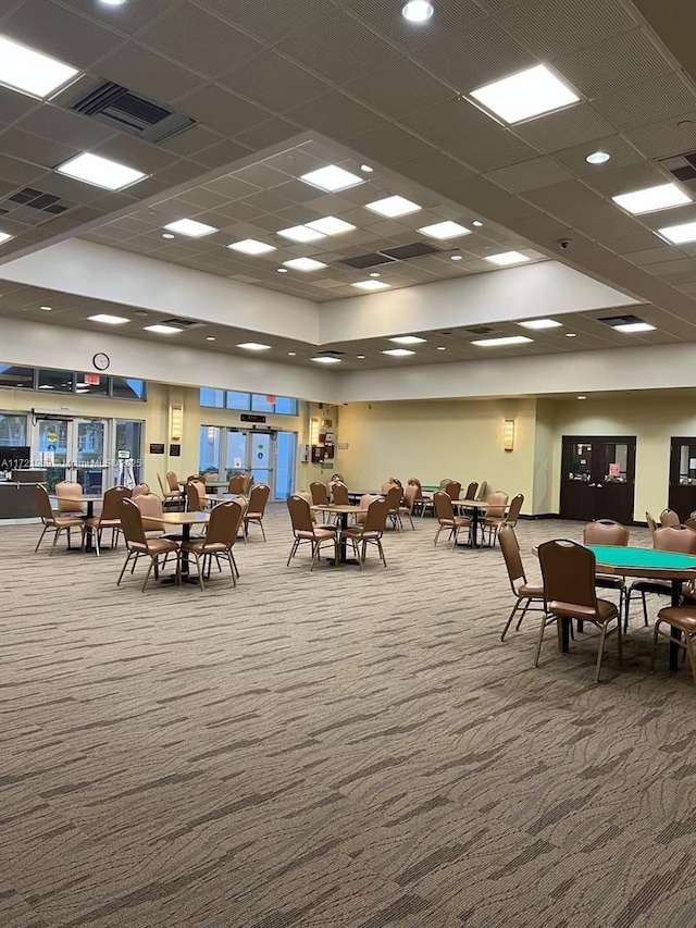 playroom featuring a paneled ceiling and carpet floors