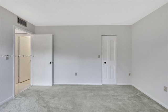 unfurnished room featuring light carpet