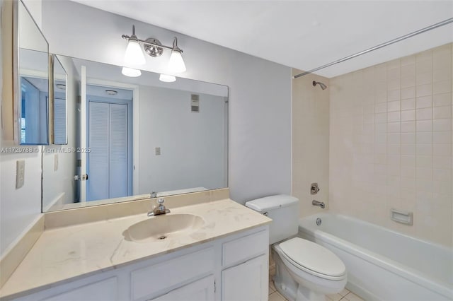 full bathroom with tiled shower / bath, tile patterned floors, vanity, and toilet