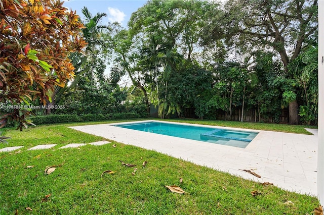 view of pool featuring a patio area and a yard