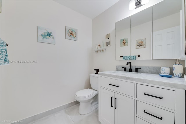 bathroom featuring tile patterned flooring, vanity, and toilet