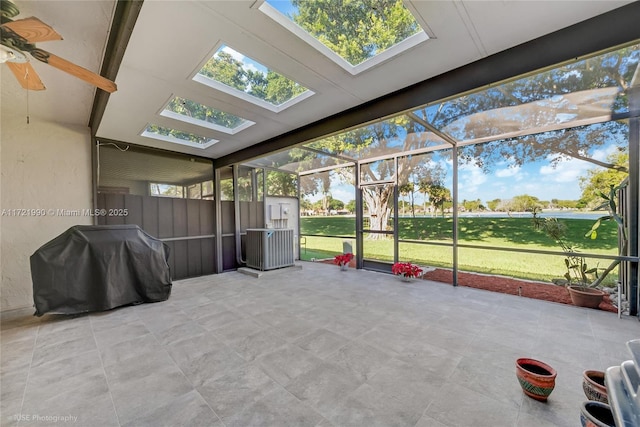 unfurnished sunroom featuring ceiling fan