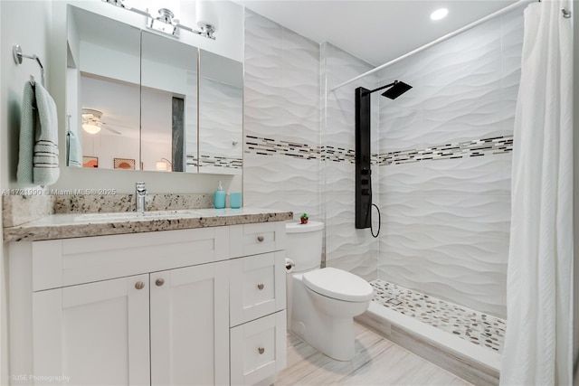 bathroom with a shower with shower curtain, vanity, and toilet