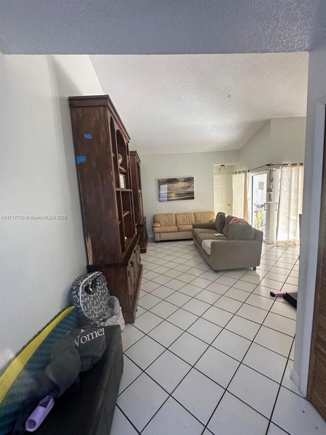 10331 SW 135th Ct, Miami, FL 33186 - tiled living room featuring a textured ceiling and vaulted ceiling
