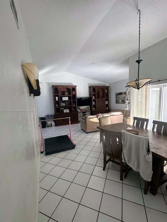 10331 SW 135th Ct, Miami, FL 33186 - dining area with a textured ceiling, light tile patterned floors, and lofted ceiling