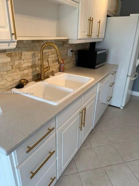 3426 Theo Way Unit 3426, West Palm Beach, FL 33417 - kitchen featuring a sink, white appliances, tasteful backsplash, white cabinets, and light tile patterned flooring
