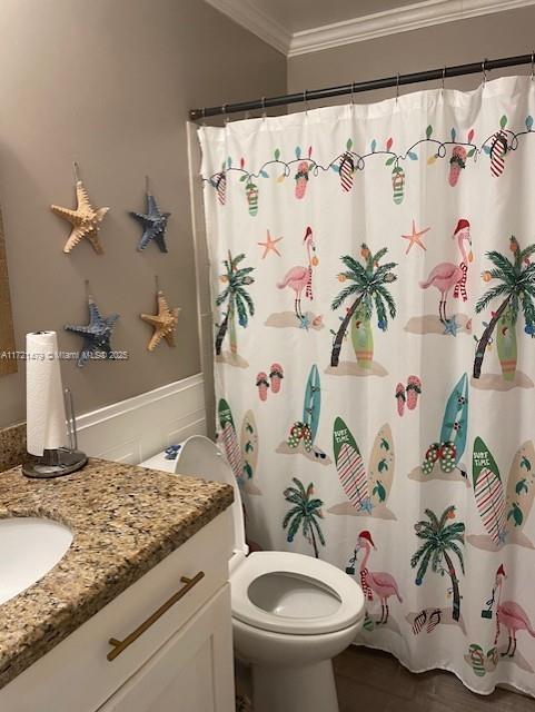 bathroom with ornamental molding, vanity, tile patterned flooring, toilet, and curtained shower