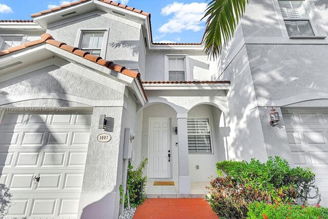 doorway to property with a garage