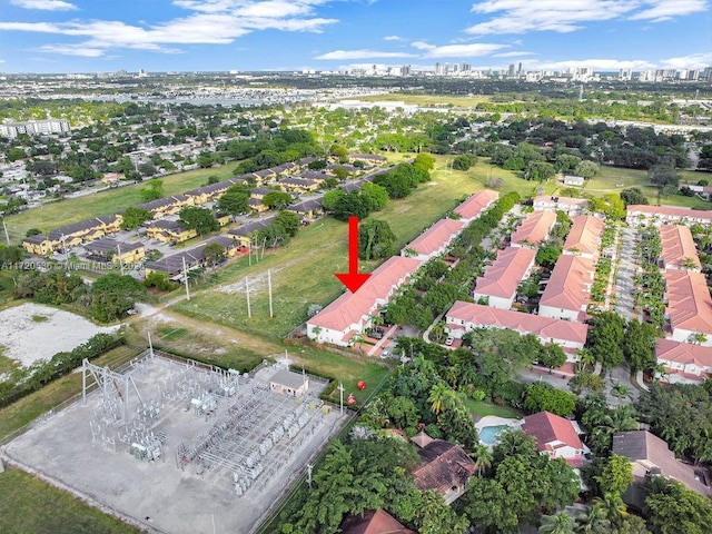 aerial view of property and surrounding area featuring nearby urban area