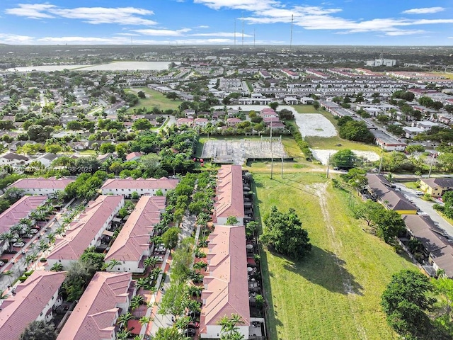 aerial view of property and surrounding area featuring nearby suburban area