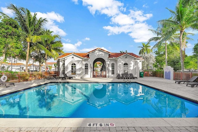 community pool featuring a patio area and fence