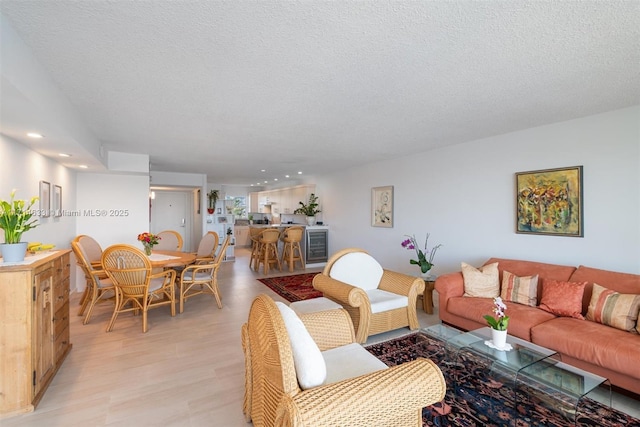 living room with light hardwood / wood-style flooring and a textured ceiling