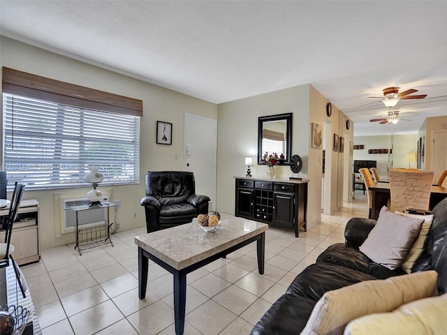 tiled living room featuring ceiling fan and a textured ceiling