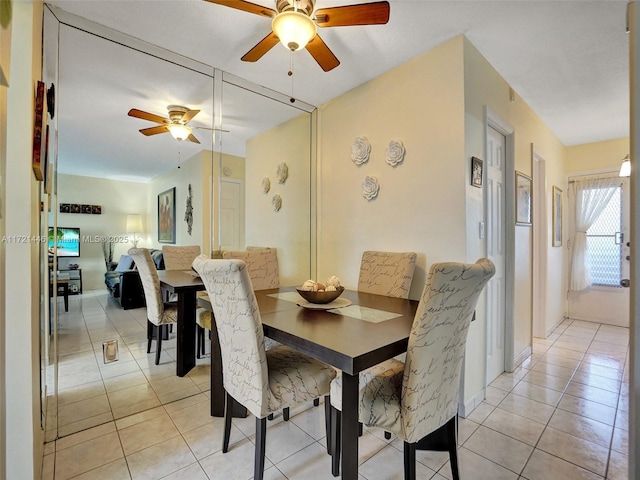 dining space featuring ceiling fan and light tile patterned floors