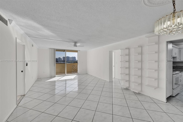 empty room featuring a textured ceiling, crown molding, and ceiling fan with notable chandelier