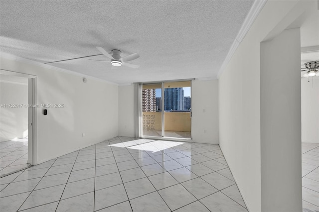 tiled spare room featuring ceiling fan, a wall of windows, ornamental molding, and a textured ceiling