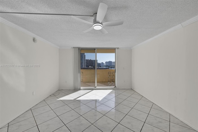 spare room with ceiling fan, crown molding, expansive windows, and a textured ceiling