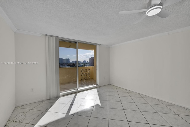 tiled empty room featuring floor to ceiling windows, ceiling fan, a textured ceiling, and ornamental molding