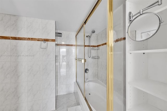 bathroom featuring combined bath / shower with glass door