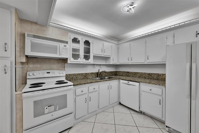 kitchen featuring white cabinetry, sink, light tile patterned floors, and white appliances