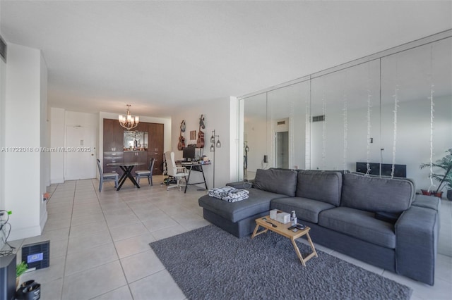 living room featuring light tile patterned floors and an inviting chandelier