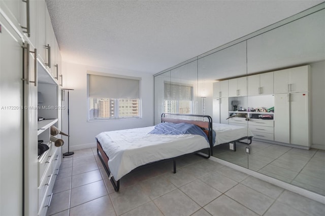 tiled bedroom with a textured ceiling