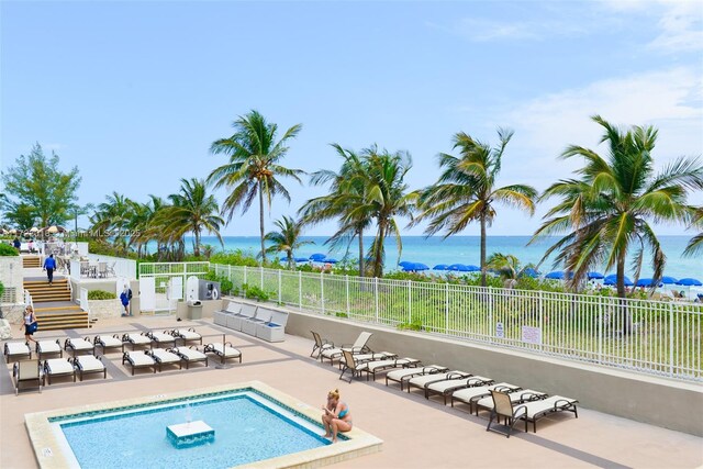 view of pool featuring a patio area and a water view