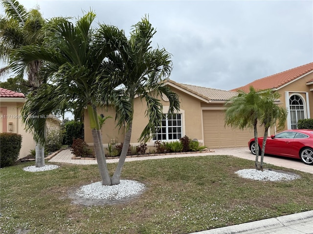 view of front facade featuring a front lawn and a garage